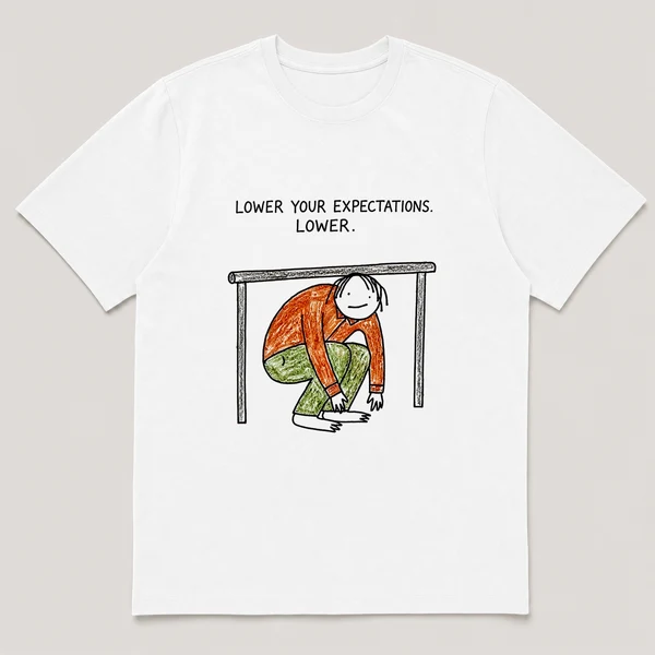 Front view of a White Tee printed with a guy crouches limbo-style under a bar that is almost touching the ground and the caption LOWER YOUR EXPECTATIONS. LOWER.