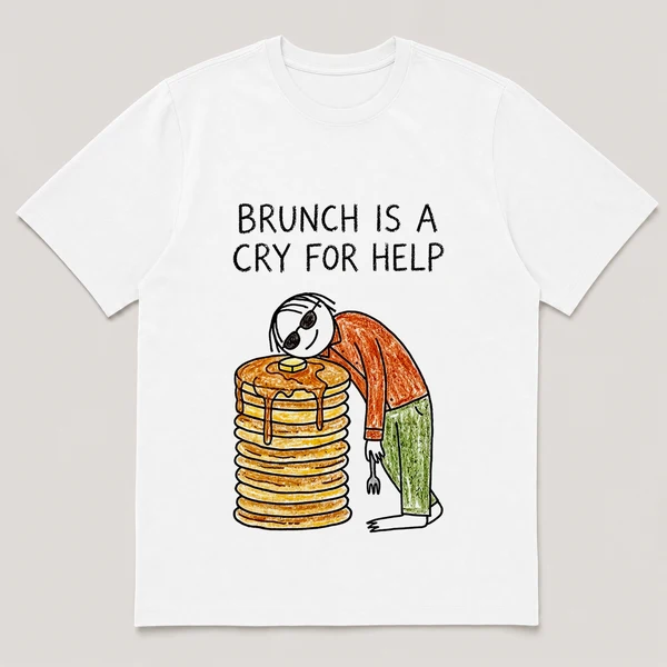 Front view of a White Tee printed with a guy in sunglasses slumps over a stack of pancakes taller than his head, fork drooping from one hand and the caption BRUNCH IS A CRY FOR HELP